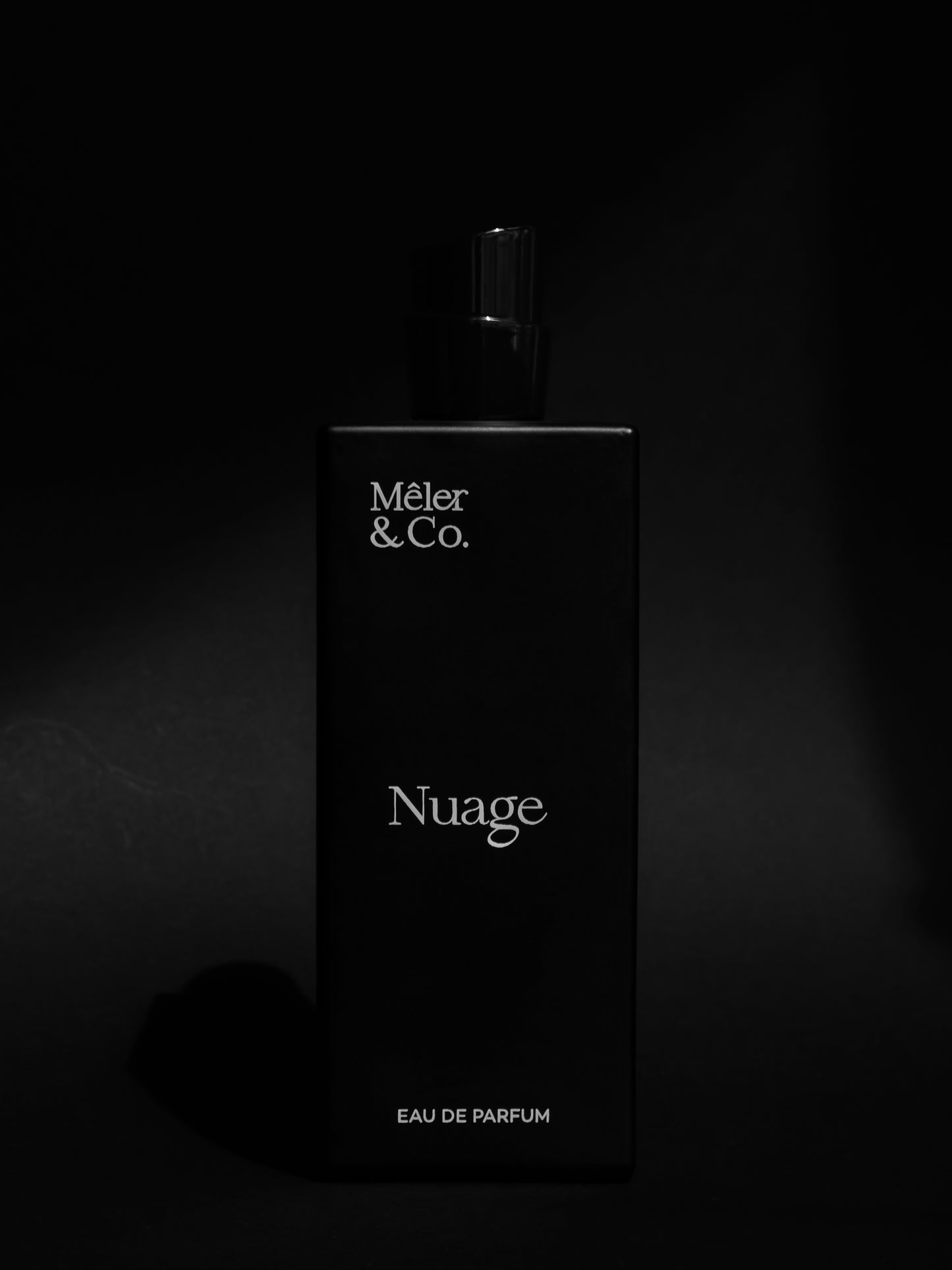 Mêler & Co. Nuage eau de parfum bottle on matte black background